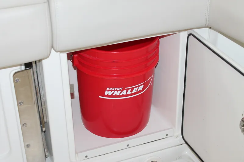 Slide: The Image of Red Boston Whaler bucket stored in 2017 Boston Whaler 330 Outrage compartment. - 29