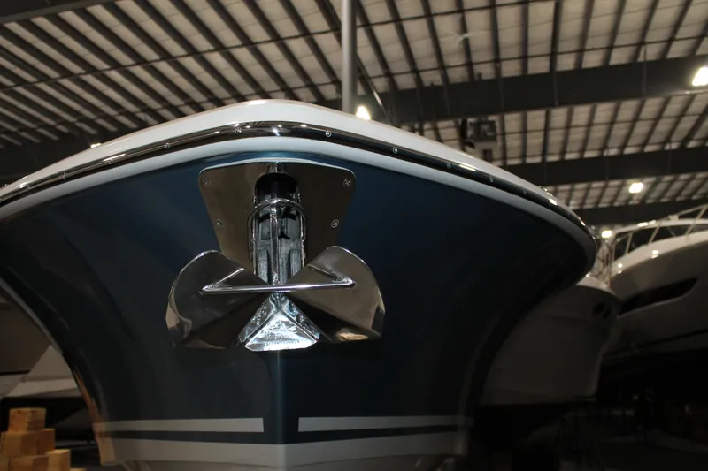 Slide: The Image of 2017 Boston Whaler 330 Outrage boat in indoor storage, showcasing bow and anchor. - 3