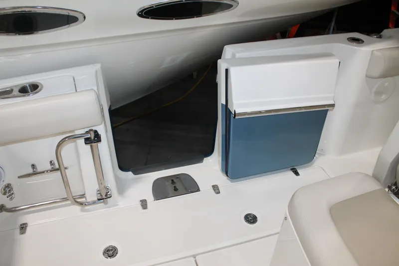Slide: The Image of 2017 Boston Whaler 330 Outrage boat interior with seating and storage compartments. - 30