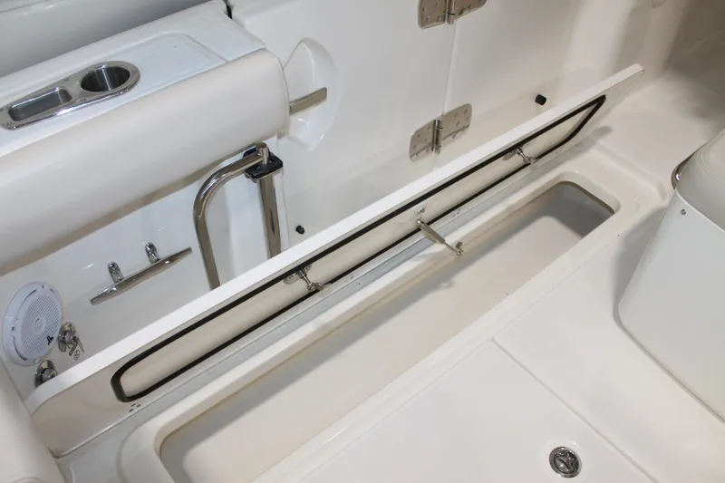 Slide: The Image of 2017 Boston Whaler 330 Outrage boat interior storage compartment with stainless steel fixtures. - 31
