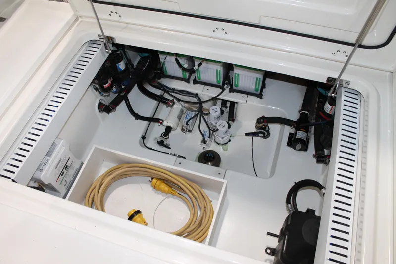 Slide: The Image of 2017 Boston Whaler 330 Outrage engine compartment with wiring and components visible. - 33