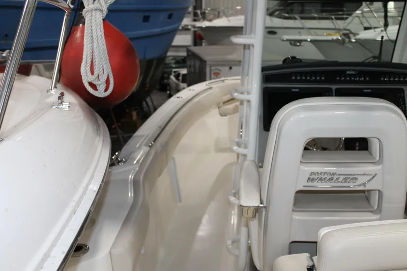 Slide: The Image of 2017 Boston Whaler 330 Outrage boat interior with helm and seating. - 37
