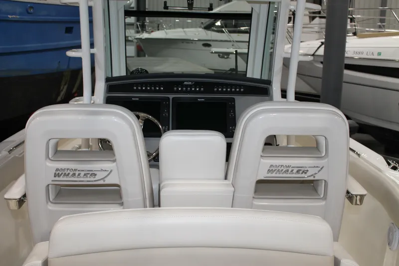 Slide: The Image of 2017 Boston Whaler 330 Outrage boat interior with helm and seating. - 38