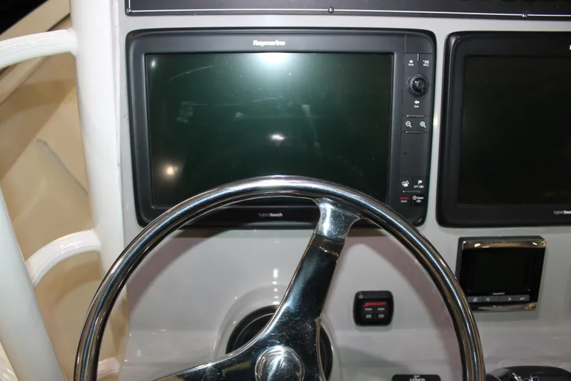 Slide: The Image of Steering wheel and dashboard of 2017 Boston Whaler 330 Outrage boat. - 44