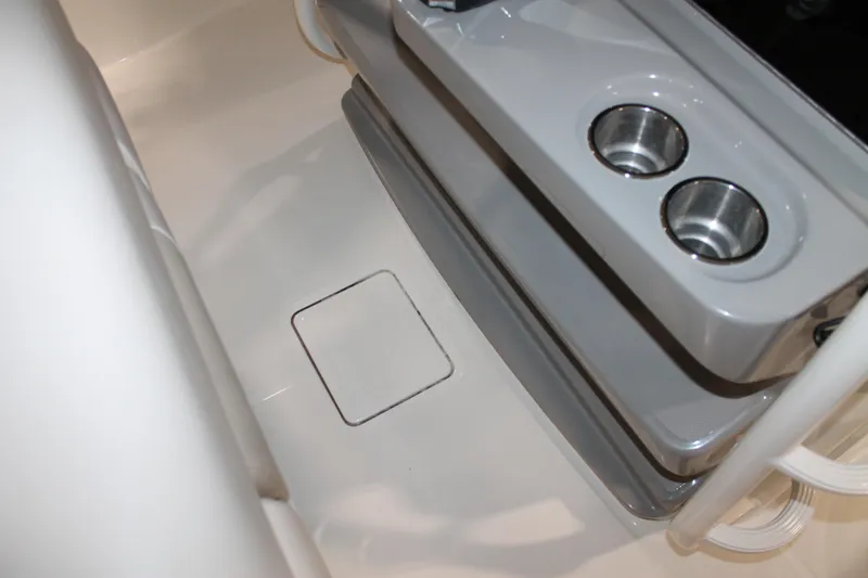 Slide: The Image of 2017 Boston Whaler 330 Outrage interior with cup holders and storage compartment. - 48