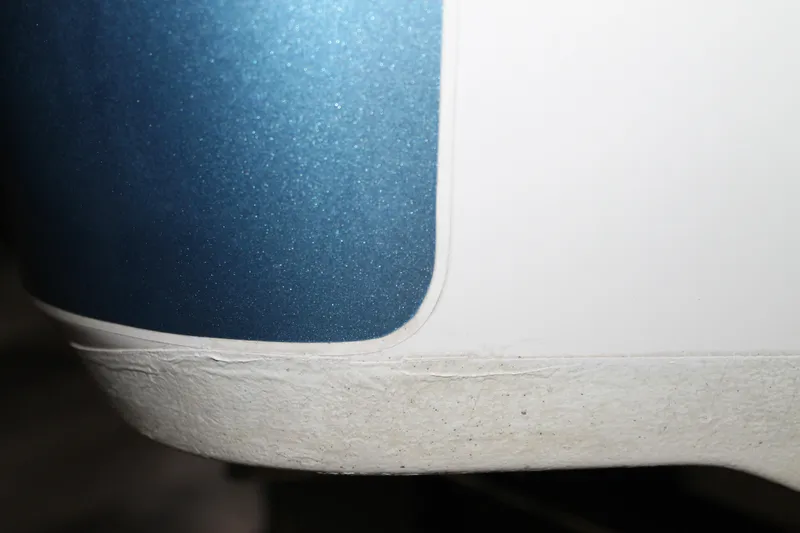 Slide: The Image of Close-up of 2017 Boston Whaler 330 Outrage boat hull with blue and white finish. - 5