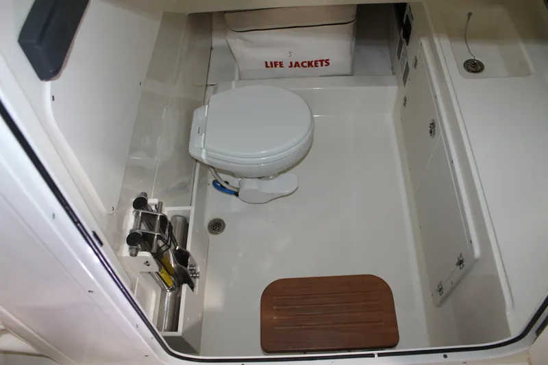 Slide: The Image of 2017 Boston Whaler 330 Outrage boat interior with toilet and life jackets. - 51