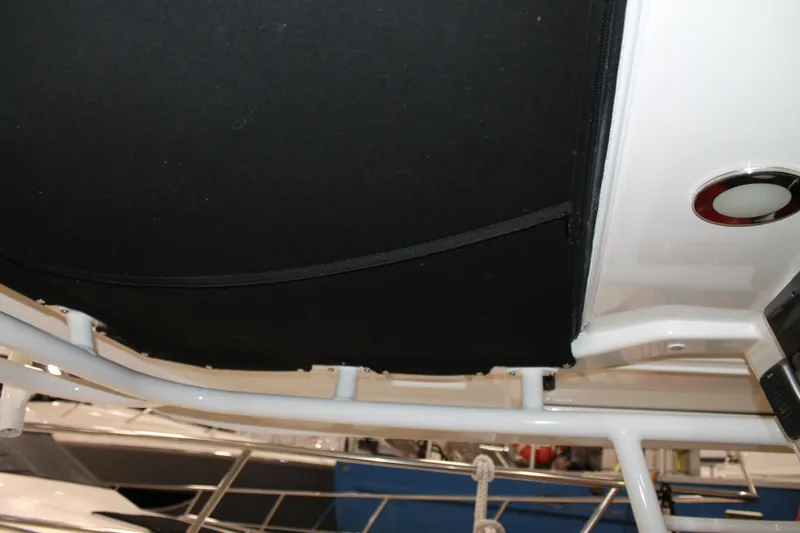 Slide: The Image of 2017 Boston Whaler 330 Outrage boat interior detail with black canopy and white frame. - 53