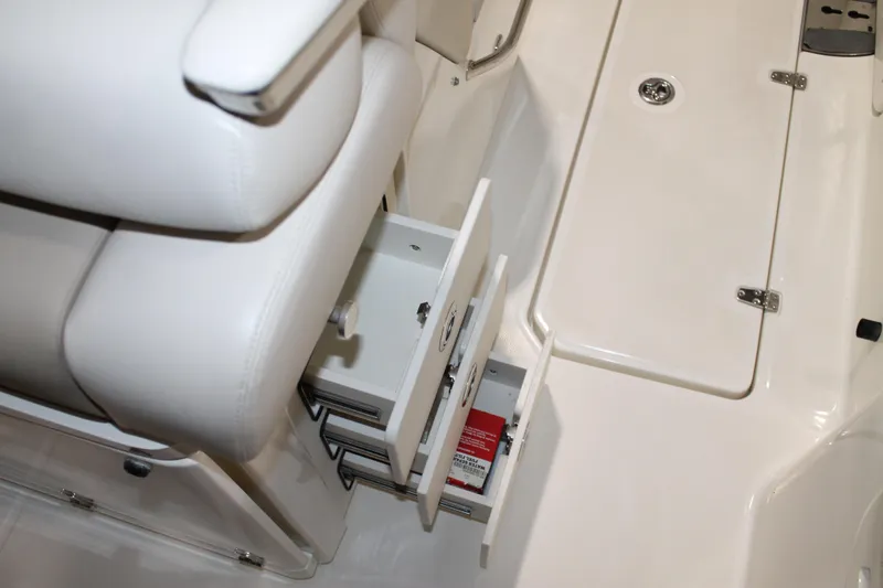 Slide: The Image of 2017 Boston Whaler 330 Outrage interior with open storage compartment and seating. - 56