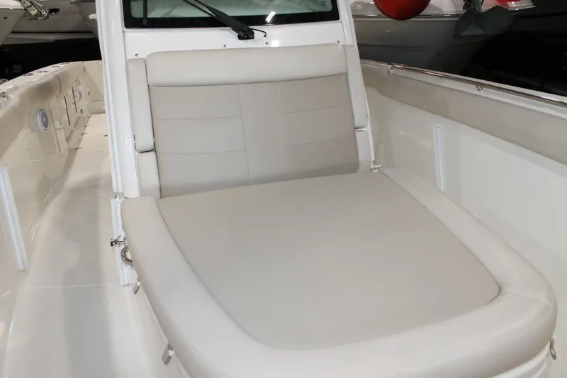 Slide: The Image of 2017 Boston Whaler 330 Outrage boat interior with cushioned seating area. - 62