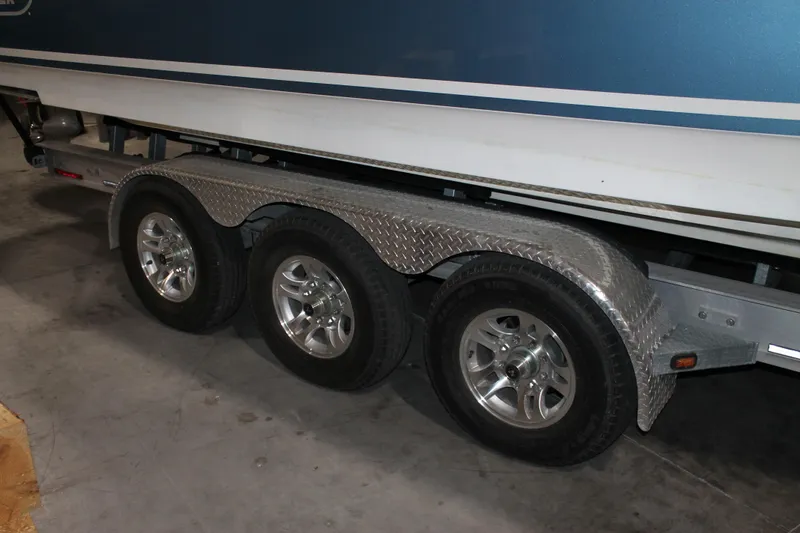 Slide: The Image of Triple-axle trailer for 2017 Boston Whaler 330 Outrage boat in a garage. - 67