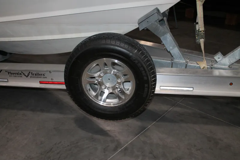 Slide: The Image of Trailer wheel of a 2017 Boston Whaler 330 Outrage boat on Phoenix Trailers. - 68