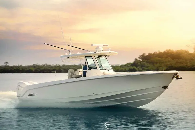 Slide: The Image of Manufacturer Provided Image: 2017 Boston Whaler 330 Outrage boat cruising on calm water at sunset. - 70