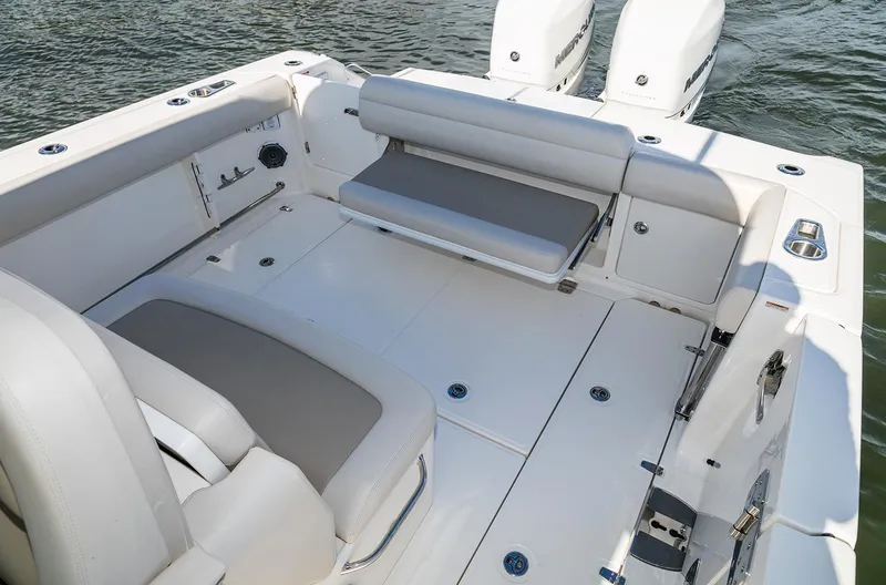 Slide: The Image of Manufacturer Provided Image: 2017 Boston Whaler 330 Outrage boat interior with seating and twin engines. - 81