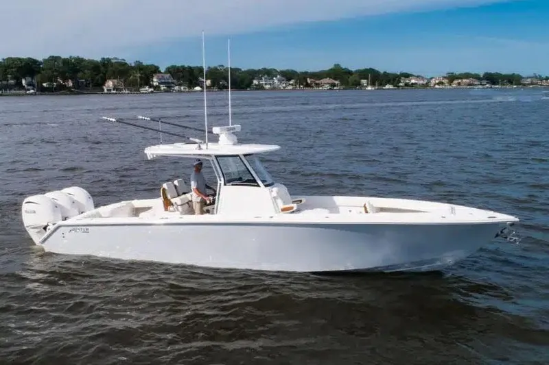 Slide: The Image of Manufacturer Provided Image: 2026 Jupiter 340LS boat cruising on a calm river with scenic shoreline. - 0