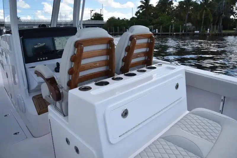 Slide: The Image of Manufacturer Provided Image: Luxury seating on a 2026 Jupiter 380LS boat with elegant wood accents and water view. - 3