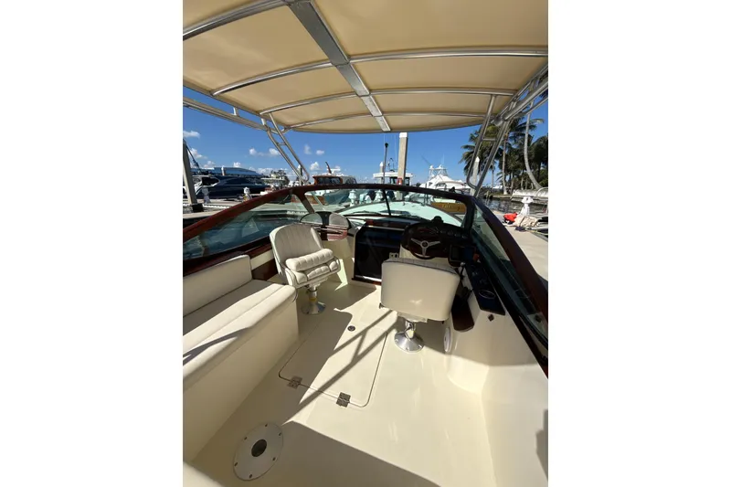Slide: The Image of 2005 Hinckley Talaria 29 Runabout interior with helm, seating, and canopy. - 5