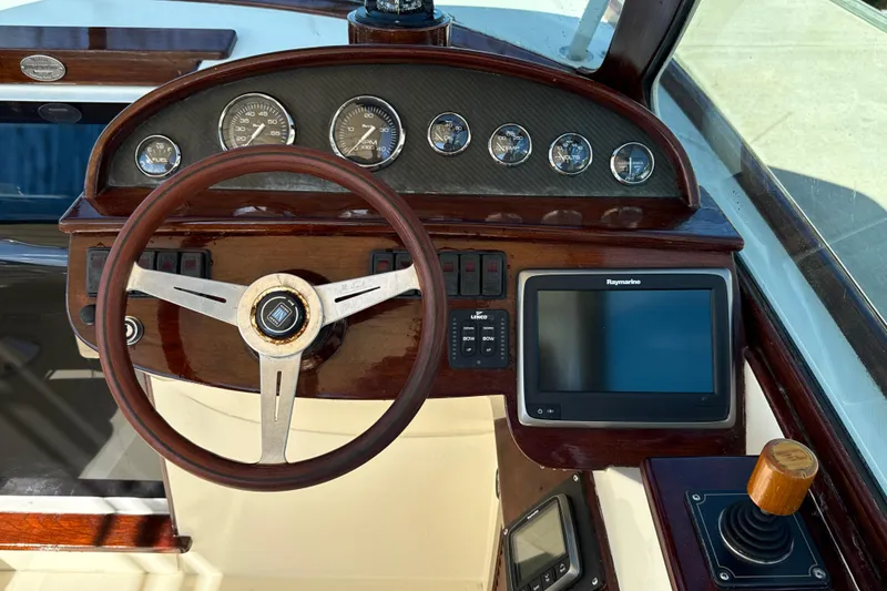 Slide: The Image of Steering wheel and dashboard of 2005 Hinckley Talaria 29 Runabout with navigation instruments. - 7