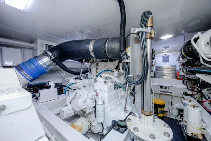 Slide: The Image of Engine room of 2009 Viking 60 Convertible yacht, showcasing mechanical components and equipment. - 100