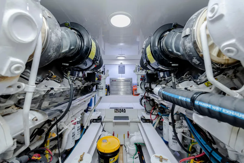 Slide: The Image of Engine room of a 2009 Viking 60 Convertible yacht, showcasing machinery and components. - 104