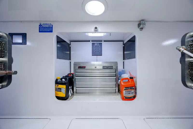 Slide: The Image of Engine room of 2009 Viking 60 Convertible with tool chest and fluid containers. - 105