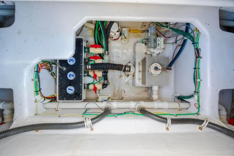 Slide: The Image of Engine compartment of a 2009 Viking 60 Convertible boat, showcasing wiring and plumbing systems. - 113