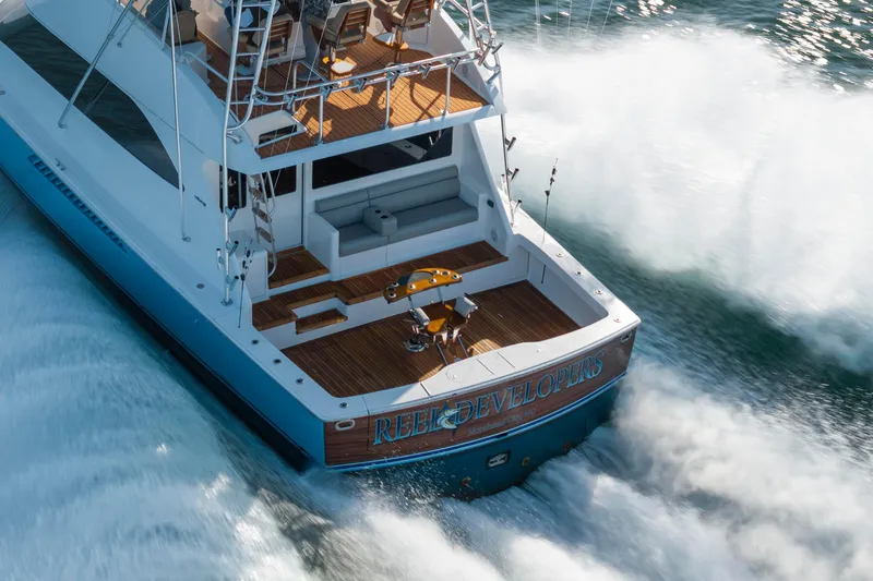 Slide: The Image of 2009 Viking 60 Convertible yacht cruising swiftly on open water. - 27