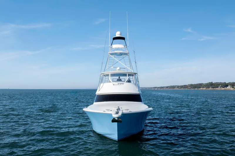 Slide: The Image of 2009 Viking 60 Convertible yacht on open water, clear sky background. - 3