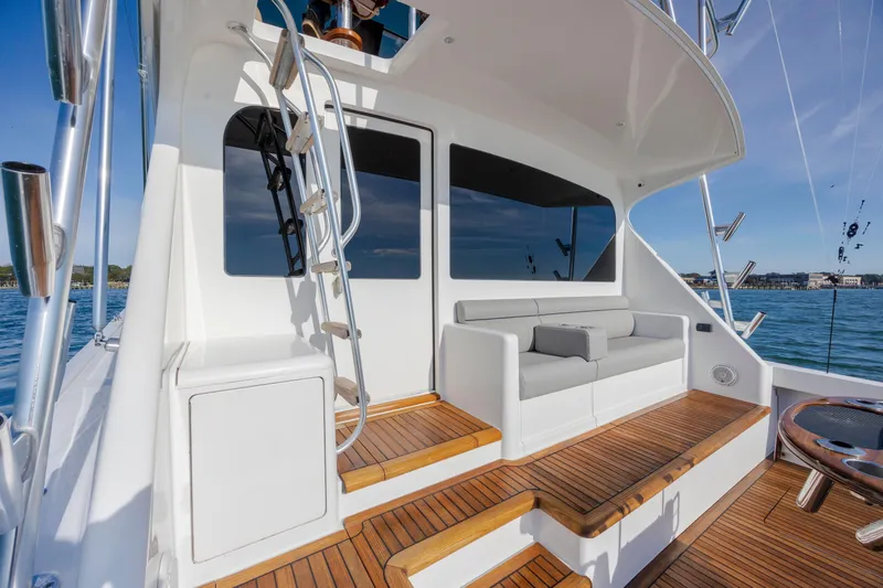 Slide: The Image of 2009 Viking 60 Convertible yacht deck with seating, ladder, and ocean view. - 31