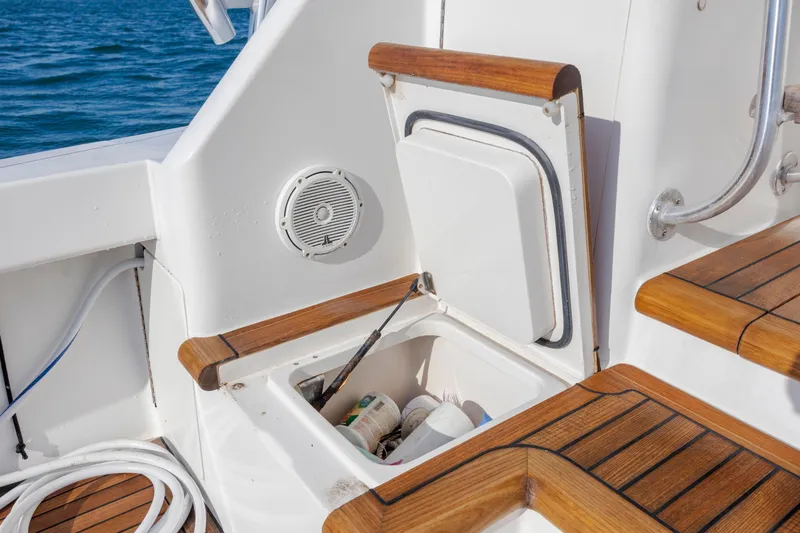 Slide: The Image of 2009 Viking 60 Convertible yacht deck with storage compartment and wooden accents. - 38