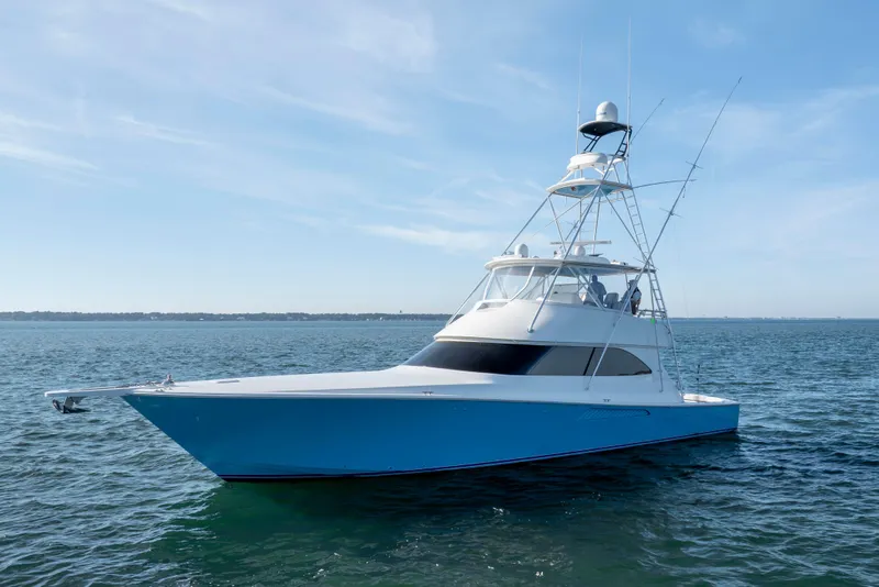 Slide: The Image of 2009 Viking 60 Convertible yacht on calm ocean waters under clear blue sky. - 4