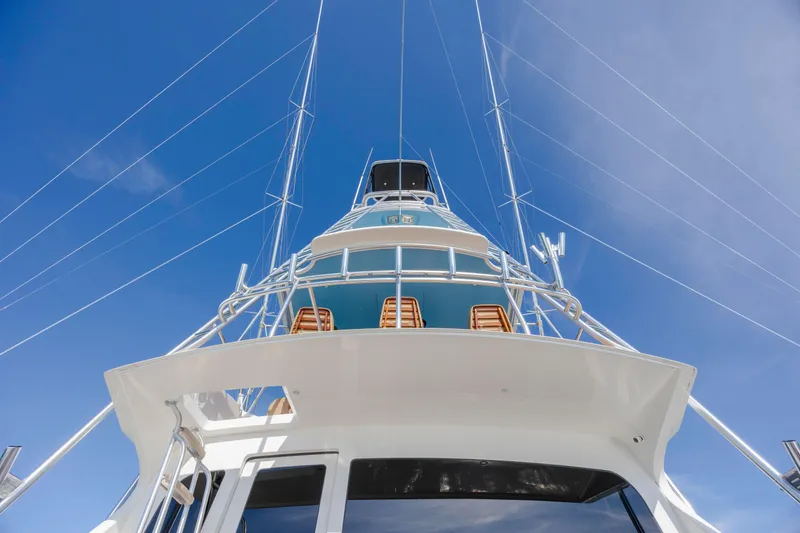 Slide: The Image of 2009 Viking 60 Convertible yacht, viewed from below against a clear blue sky. - 42