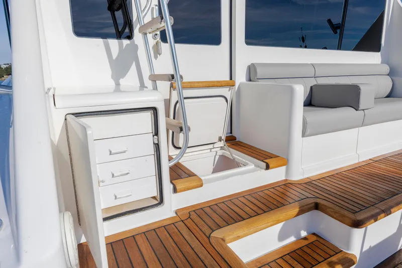 Slide: The Image of 2009 Viking 60 Convertible yacht interior with teak flooring and seating area. - 43