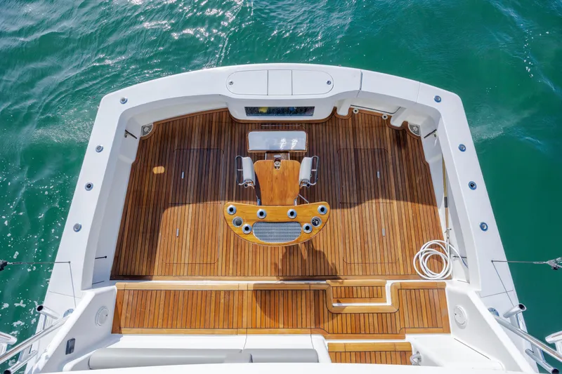 Slide: The Image of 2009 Viking 60 Convertible yacht deck with wooden flooring and fishing chair. - 45
