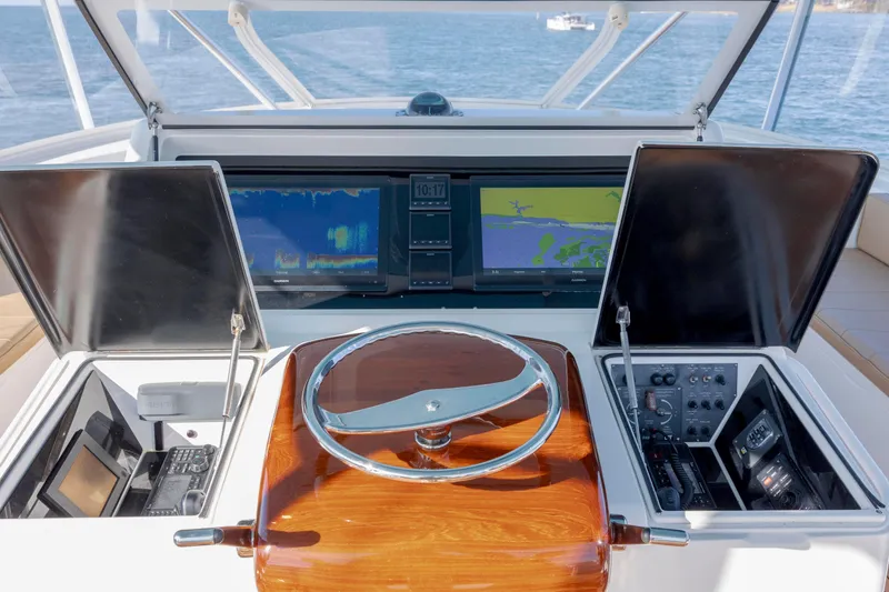 Slide: The Image of 2009 Viking 60 Convertible yacht helm with navigation screens and controls. - 48