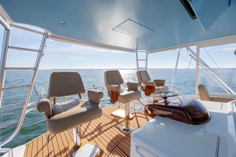 Slide: The Image of Luxurious 2009 Viking 60 Convertible yacht helm with ocean view and elegant seating. - 52