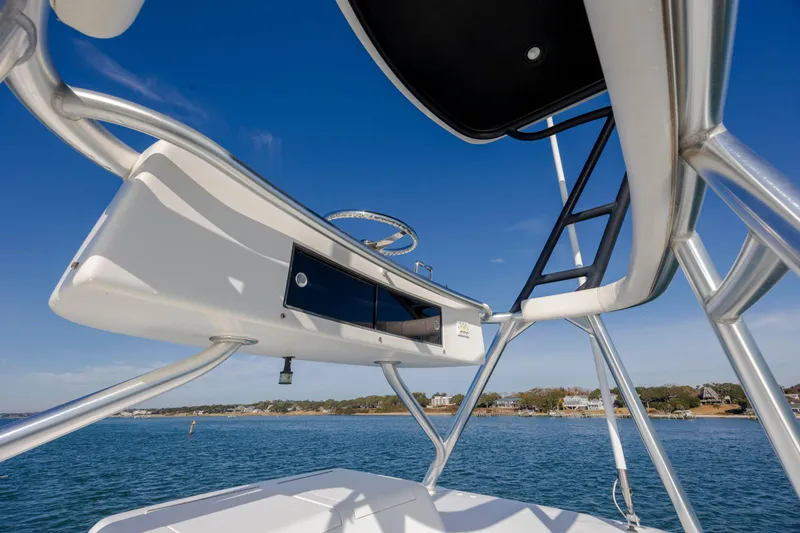 Slide: The Image of 2009 Viking 60 Convertible yacht, view of tower and helm, against clear blue sky. - 58