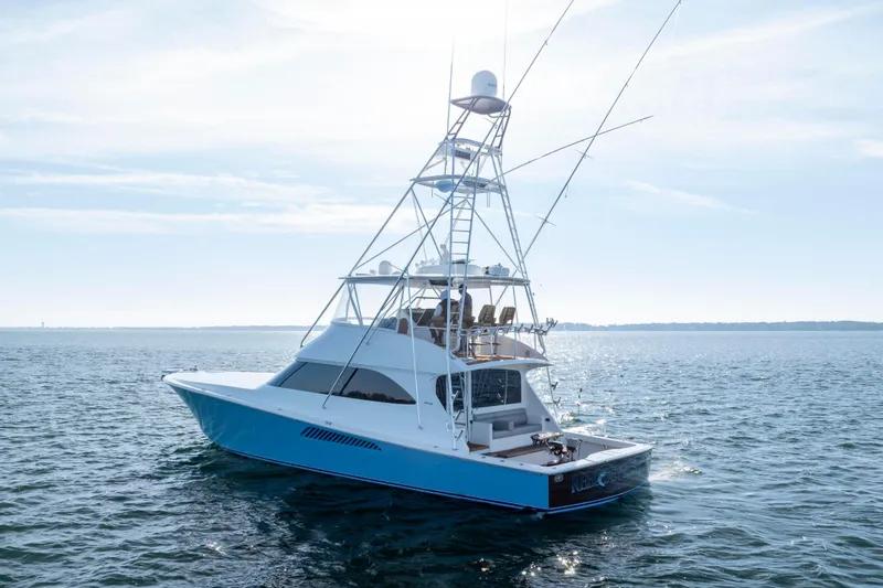 Slide: The Image of 2009 Viking 60 Convertible yacht on open water, showcasing sleek design and fishing tower. - 6