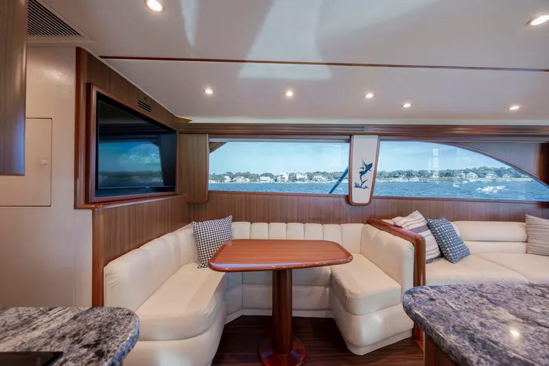 Slide: The Image of Luxurious interior of 2009 Viking 60 Convertible yacht with elegant seating and scenic window view. - 69