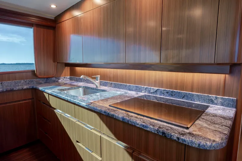 Slide: The Image of Luxurious kitchen interior of 2009 Viking 60 Convertible yacht with wood cabinetry and granite countertops. - 76