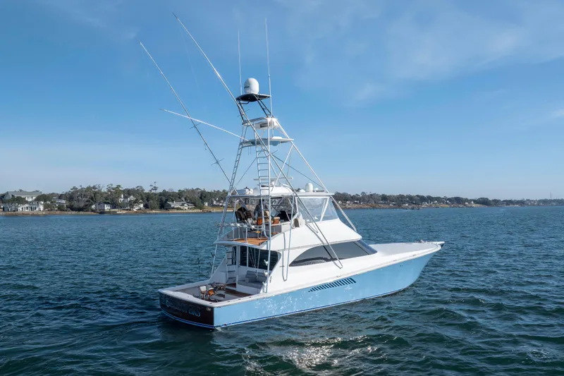 Slide: The Image of 2009 Viking 60 Convertible yacht on calm waters under clear blue sky. - 8