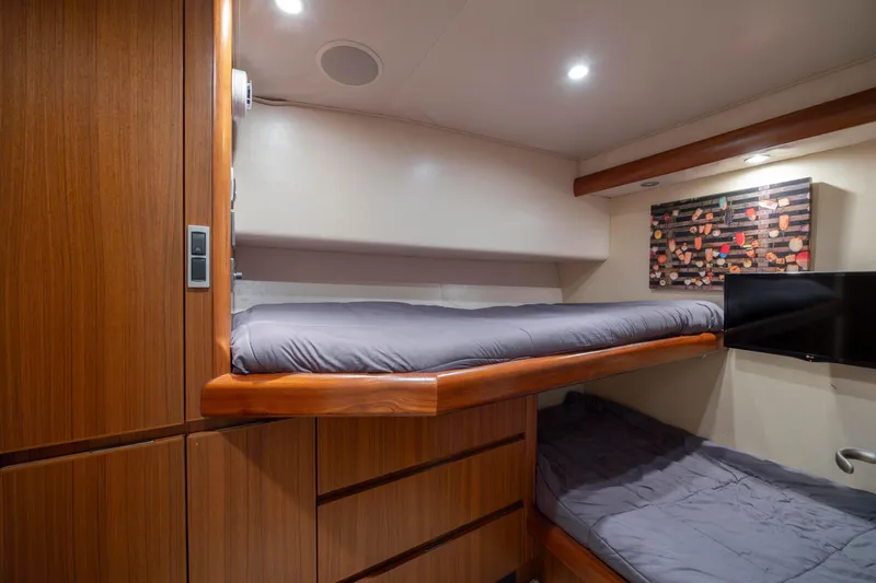 Slide: The Image of Luxurious 2009 Viking 60 Convertible yacht cabin with wooden finish and modern amenities. - 80