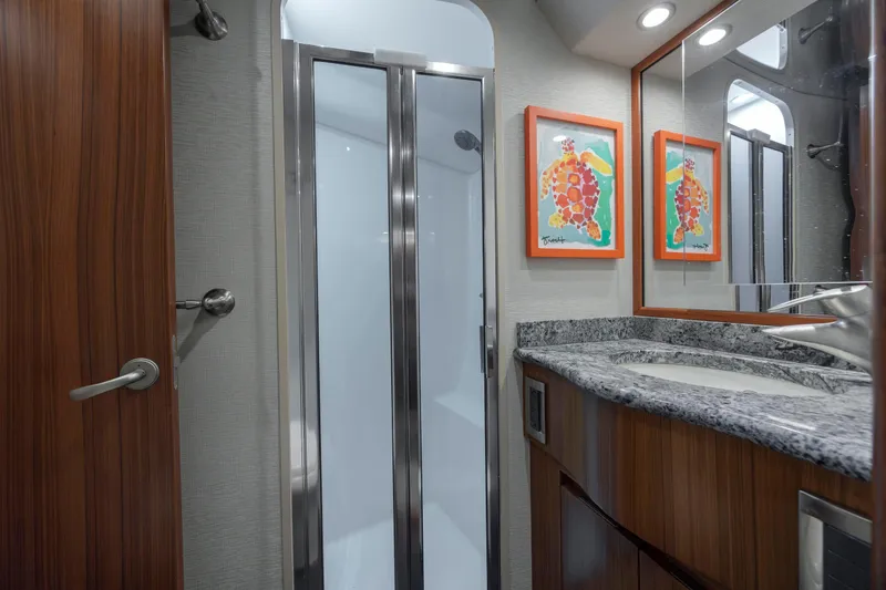 Slide: The Image of Luxurious bathroom in 2009 Viking 60 Convertible yacht with granite countertop and modern shower. - 84