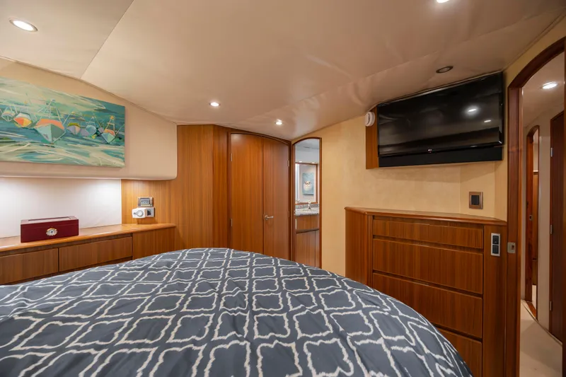 Slide: The Image of Luxurious 2009 Viking 60 Convertible yacht bedroom with modern decor and wood finishes. - 87