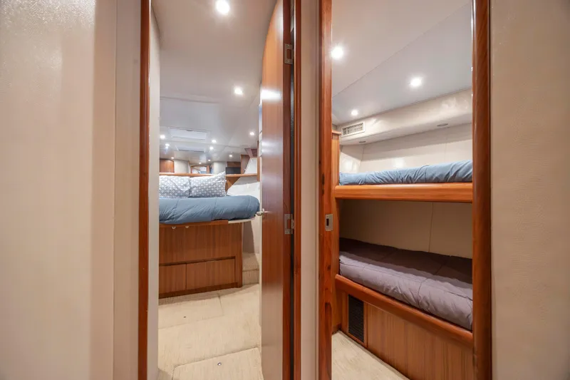 Slide: The Image of Interior of 2009 Viking 60 Convertible yacht with cozy bunk beds and elegant wood finish. - 92