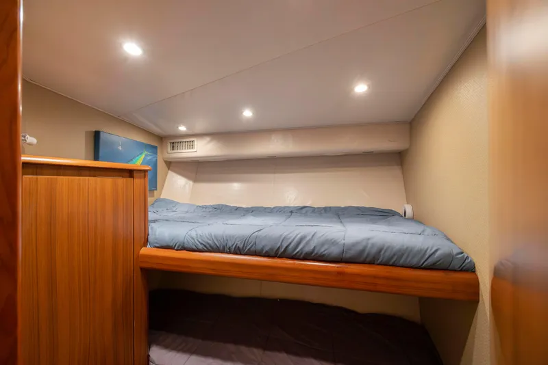 Slide: The Image of Cozy cabin interior of 2009 Viking 60 Convertible yacht with bunk beds. - 93