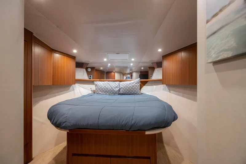 Slide: The Image of Luxurious cabin interior of 2009 Viking 60 Convertible yacht with cozy bed and wooden cabinetry. - 95