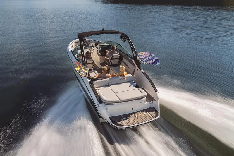 Slide: The Image of 2025 Sea Ray SLX 260 Surf boat, sleek design, blue and white color scheme. - 2