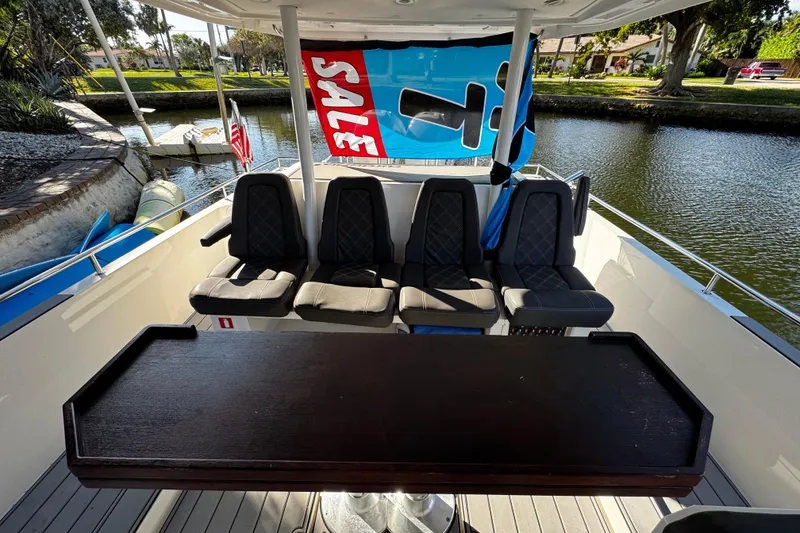 Slide: The Image of 2017 Axopar 37 Sun Top boat interior with seating and "For Sale" sign. - 13