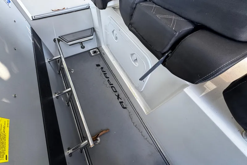 Slide: The Image of Interior view of 2017 Axopar 37 Sun Top boat, featuring seating and storage area. - 16